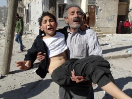 A Syrian man carried a wounded child after a reported air strike