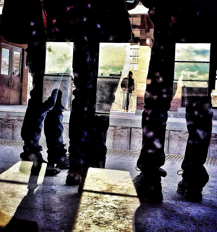 Youths through a window.