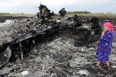 A Ukrainian woman wanders through the wreckage. Source: AAP