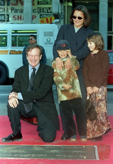 Robin Williams poses with son Cody (C), daughter Zelda (R) and ex-wife Marsha with his Hollywood handprint plaque.