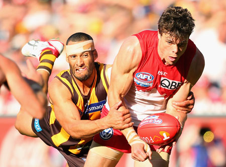 Josh Gibson epitomises Hawthorn's desperation in this tackle of Mike Pyke. Photo: Getty