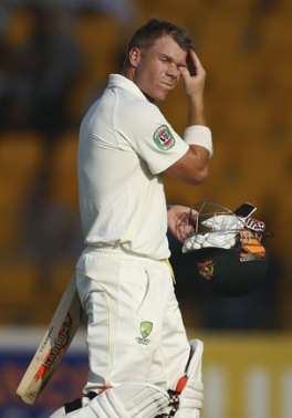 Devastated Australian cricketer David Warner and his wife, Candice Falzon, leave St Vincent's Hospital following Cricket Australia's announcement of the death of Phillip Hughes. Photo: AAP