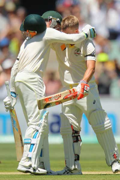 Michael Clarke and Warner shared a long embrace after the latter brought up his ton. Photo: Getty