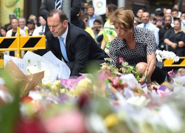 Tony Abbott and his wife Margaret lay wreaths at a makeshift memorial in Martin Place.