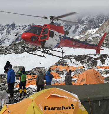 A rescue helicopter prepares to land and airlift the injured from Everest Base Camp, befall earthquake
