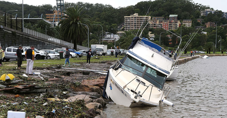 A boat is washed up on the Gosford Waterfront on the Central Coast.