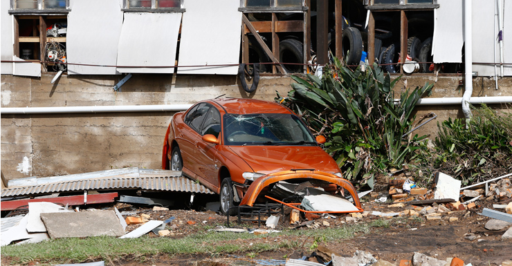 A car among debris of houses destroyed by cyclonic winds in Dungog.