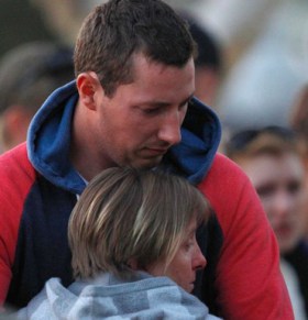 Stephanie Scott's fiance Aaron Leeson-Woolley is consoled by family as he visits the memorial.