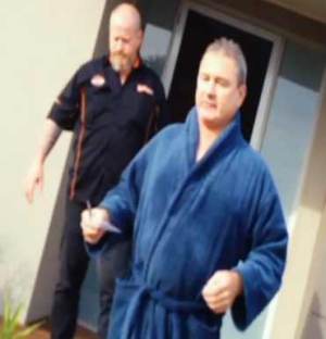 Baron in terry-toweling robe and one of his former colleagues on secret camera footage shown on A Current Affair. 