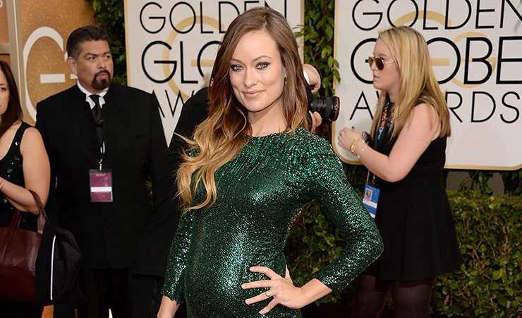 Olivia Wilde proudly shows off her mumbod on the red carpet. Photo: Getty