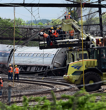 Rescuers work around derailed carriages of an Amtrak train in Philadelphia.