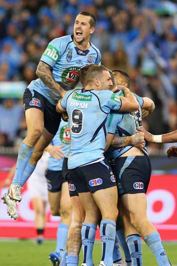 The Blues surround Josh Dugan after his try put them in control. Photo: Getty