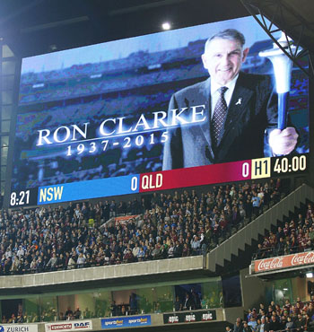 The crowd stands for a minutes silence for running legend Ron Clarke.