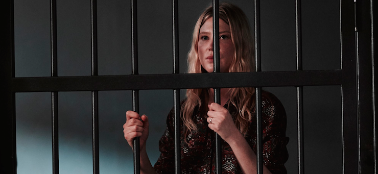 The back-from-the-dead Kate (Emma Booth) behind bars.