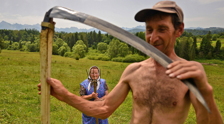 Highlanders: "Traditional haymaking in Poland. Many people continue to use the scythe and pitchfork to sort the hay. Photo: Bart Omiej Jurecki - National Geographic Traveler Photo Contest