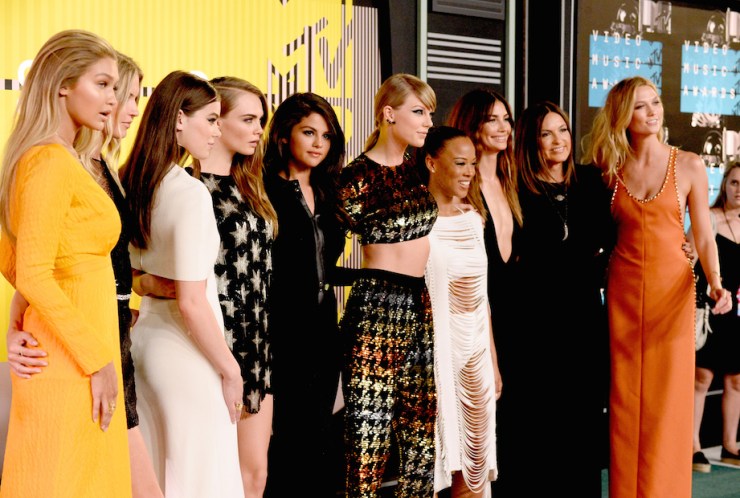 Taylor Swift walks the carpet with her 'Bad Blood' crew (L-R): Gigi Hadid, Martha Hunt, Hailee Steinfeld, Cara Delevingne, Selena Gomez. Taylor Swift, Serayah McNeill, Lily Aldridge, Mariska Hargitay and Karlie Kloss. 