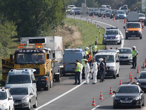 Investigators examine the truck, which was found near the border of Hungary and Austria. Photo: AAP