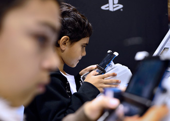 Kids may be ruining their vision by absorbing screen light rather than the sun. Photo: Getty