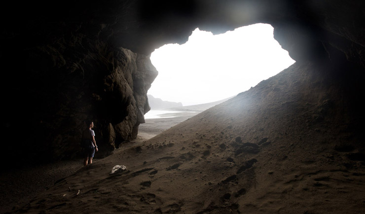 TONGA - JULY 10:  (AUSTRALIA & NEW ZEALAND OUT) Journalist, Peter Munro, stands in a cave on the newest island on Earth, July 10, 2015. It emerged from the waters of the South Pacific in January 2015 when a volcano erupted on the nearby island of Tonga, forcing pulverised magma into the air above the ocean. The magma gradually built up on the ocean floor, penetrating the surface of the water to form the island. (Photo by Edwina Pickles/The Sydney Morning Herald/Fairfax Media via Getty Images)