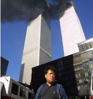 People evacuate the area around the World Trade Center after it was hit by two planes on September 11, 2001 in New York.