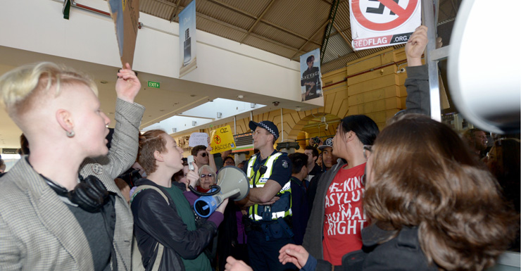Protesters rally inside Flinders Street Station.