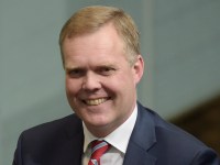 Newly elected Speaker of the House of Representatives Tony Smith (centre) is dragged to the Speaker's chair in the House of Representatives at Parliament House in Canberra, Monday, Aug. 10, 2015. (AAP Image/Lukas Coch) NO ARCHIVING