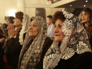 Assyrian Christians from Iraq, Syria and Lebanon attend a Christmas mass at Saint Georges church in an eastern Beirut suburb on December 25, 2014. AFP PHOTO / ANWAR AMRO (Photo credit should read ANWAR AMRO/AFP/Getty Images)