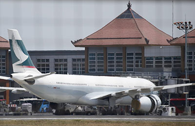 epa04947990 A Cathay Pacific aircraft is parked at Bali's Ngurah Rai International Airport after it made an emergency landing in Bali, Indonesia, 25 September 2015. The Airbus A330 Flight CX170 with 251 passengers on board, which was enroute from Perth, Australia, to Hong Kong, China, landed safely in Denpasar after an engine caught fire mid-flight, the airline later confirmed. EPA/MADE NAGI