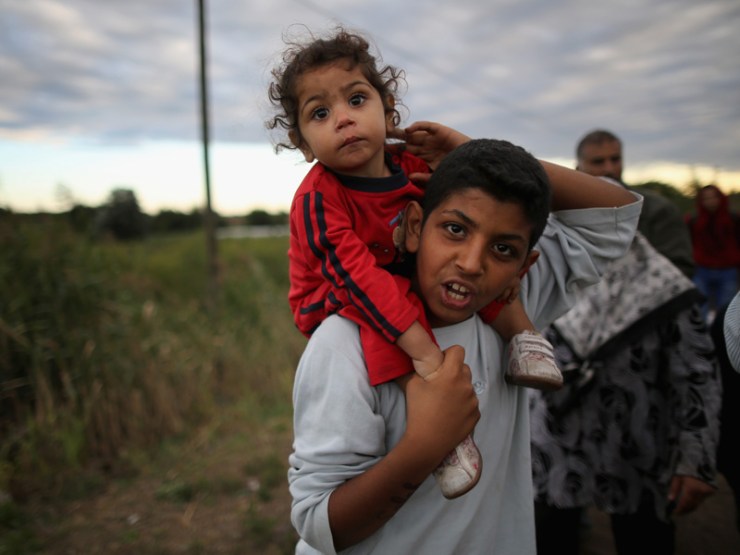 Refugees cross the border from Serbia into Hungary. Photo: Getty