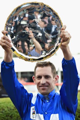 Bowman lifts the Cox Plate after steering Winx to a huge win. Photo: Getty
