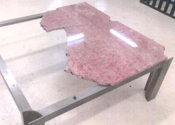 Senator Penny Wong showed photos of the damaged table at the senate committee on Monday. Photo: Twitter