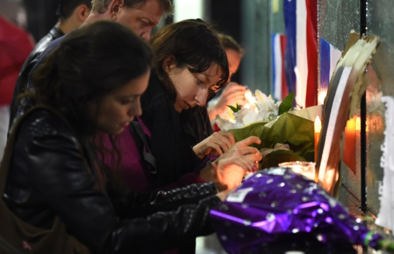 Members of Sydney's French community light candles at a vigil in Martin Place. Photo: Getty