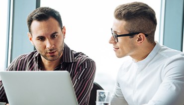 Two young successful businessmen brainstorming on stratup business crowdfunding