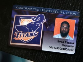 The California State University Fullerton student identification of Syed Farook sits on a desk.