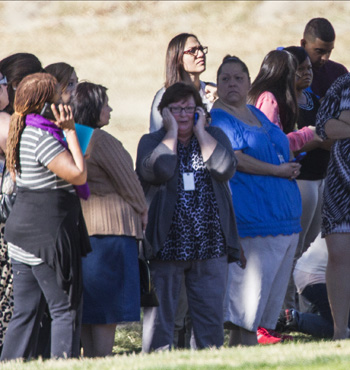 Workers from the centre huddle together after they were evacuated.