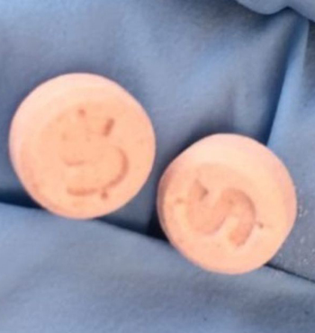 Police believe red and orange pills stamped with dollar signs found on Stefan Woodward were responsible.