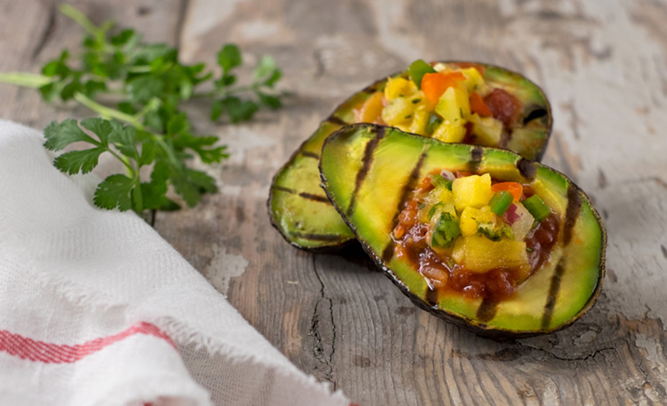 Avocado tastes even better when grilled. Photo: Getty