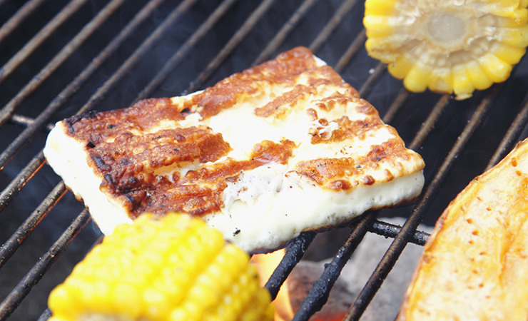 Oozy cheese like saganaki or haloumi (pictured) is best cooked on a hot plate. Photo: Getty