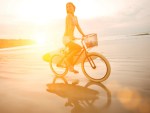 female cyclist no helmet beach