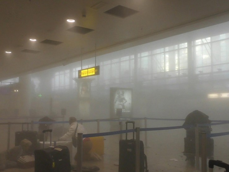 Travellers make their way through the smoke-filled Zaventern Airport. Photo: AP