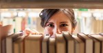 Woman grabbing book at bookstore
