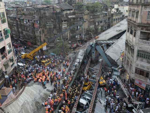 Emergency services and volunteers work to try and free people trapped under rubble.