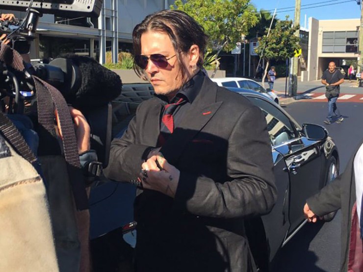 Johnny Depp arrives to a throng of awaiting media.