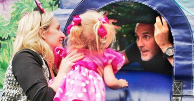 Box and her daughter play with Kenny in the backyard.