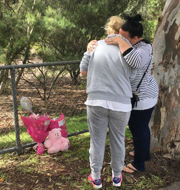 West Heidelberg residents Michelle and Faye leave a floral tribute for toddler Sanaya Sahib.