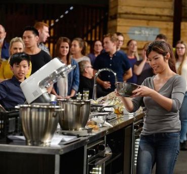 MasterChef contestant Cecilia (right) cooks while her son Nathan looks on. Photo: Network Ten