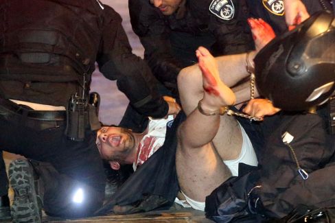Israeli policemen arrest a suspect man shortly after the shooting. Photo: Getty.