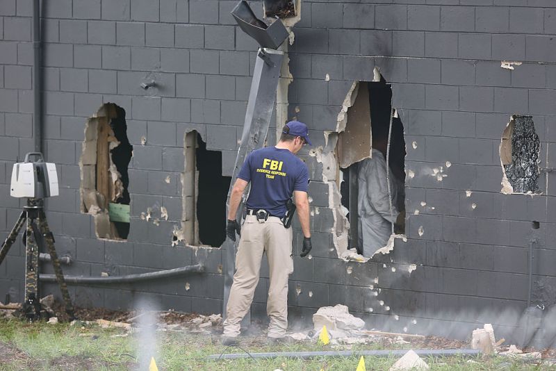 FBI agents investigate the damaged rear wall of the Pulse Nightclub. Photo: Getty.