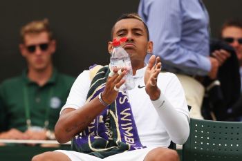 Nick Kyrgios takes a drink during a break at Wimbledon against Richard Gasquet.