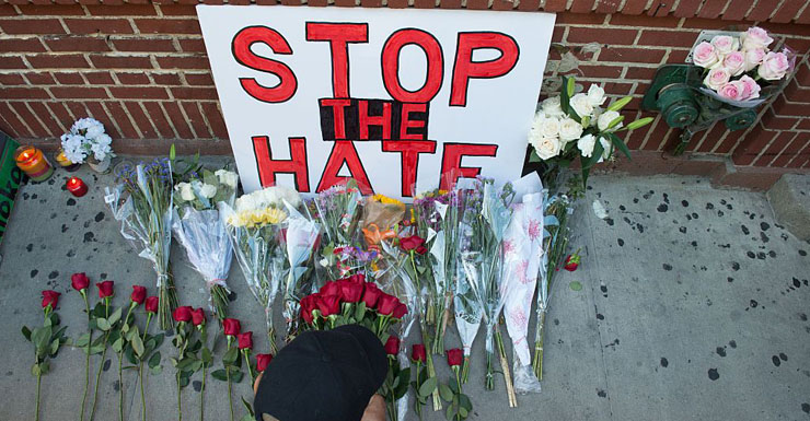 Mourners lay flowers during a vigil in reaction to the mass shooting at a gay nightclub in Orlando, Florida,in New York